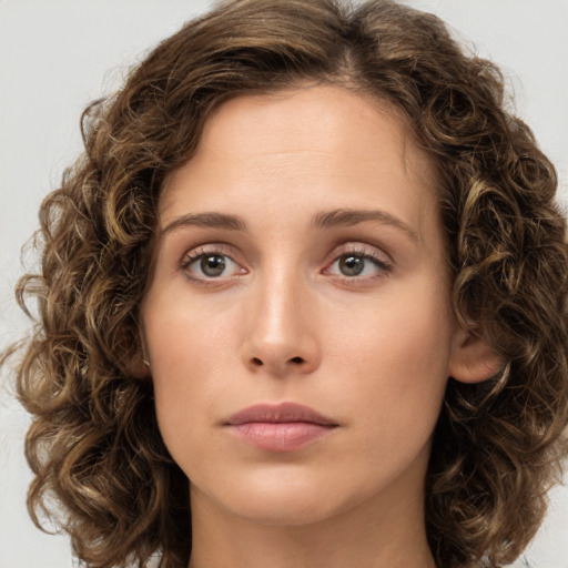 Joyful white young-adult female with medium  brown hair and green eyes