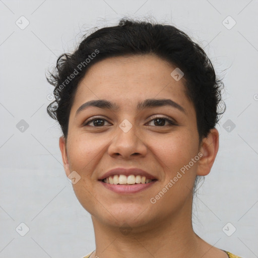 Joyful latino young-adult female with short  brown hair and brown eyes