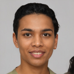 Joyful latino young-adult male with short  black hair and brown eyes