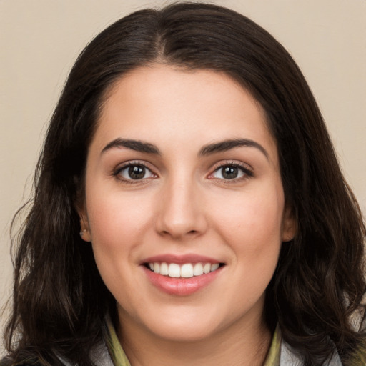 Joyful white young-adult female with long  brown hair and brown eyes