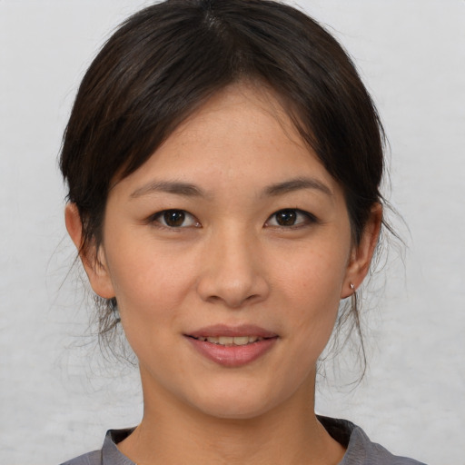 Joyful asian young-adult female with medium  brown hair and brown eyes