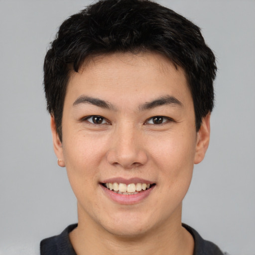 Joyful asian young-adult male with short  brown hair and brown eyes