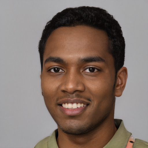 Joyful black young-adult male with short  black hair and brown eyes