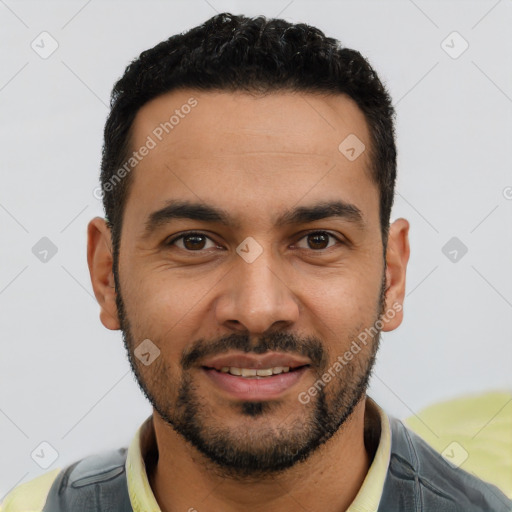 Joyful latino young-adult male with short  black hair and brown eyes