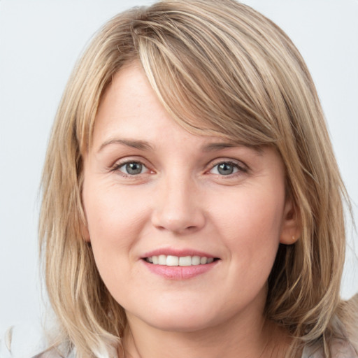 Joyful white young-adult female with medium  brown hair and blue eyes