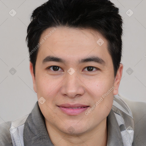 Joyful asian young-adult male with short  black hair and brown eyes