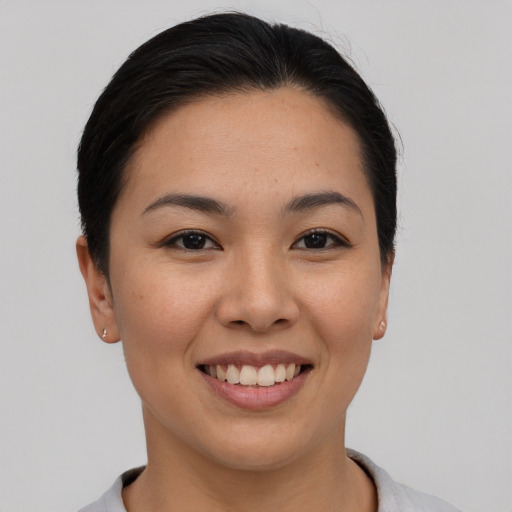 Joyful asian young-adult female with short  black hair and brown eyes