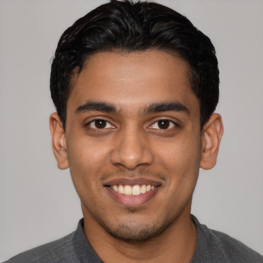 Joyful latino young-adult male with short  brown hair and brown eyes