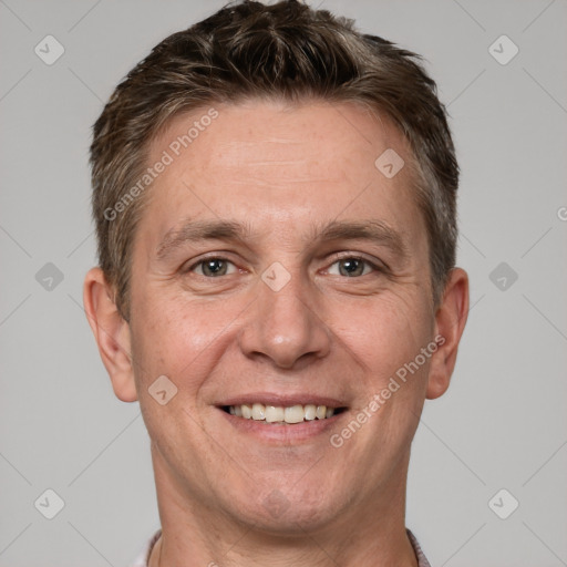 Joyful white adult male with short  brown hair and grey eyes