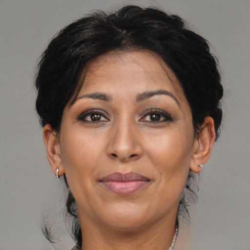 Joyful asian adult female with medium  brown hair and brown eyes