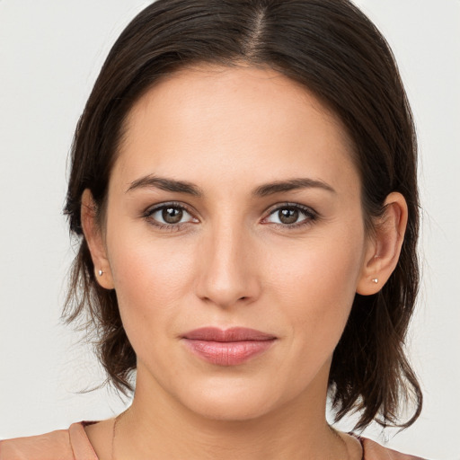 Joyful white young-adult female with medium  brown hair and brown eyes