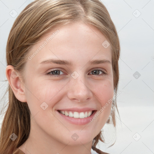 Joyful white young-adult female with long  brown hair and blue eyes