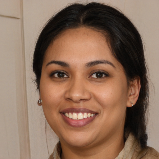 Joyful white young-adult female with long  brown hair and brown eyes