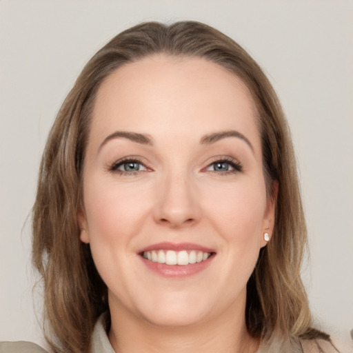 Joyful white young-adult female with medium  brown hair and grey eyes