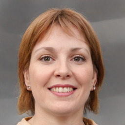 Joyful white young-adult female with medium  brown hair and blue eyes