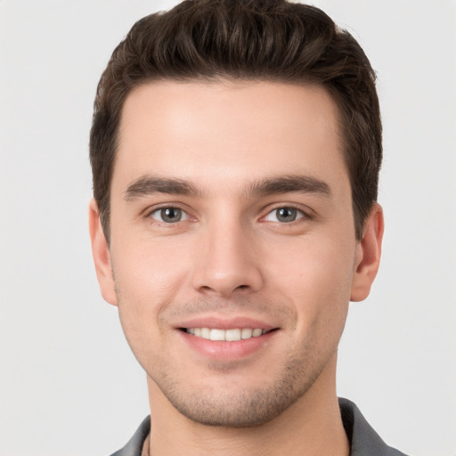 Joyful white young-adult male with short  brown hair and brown eyes