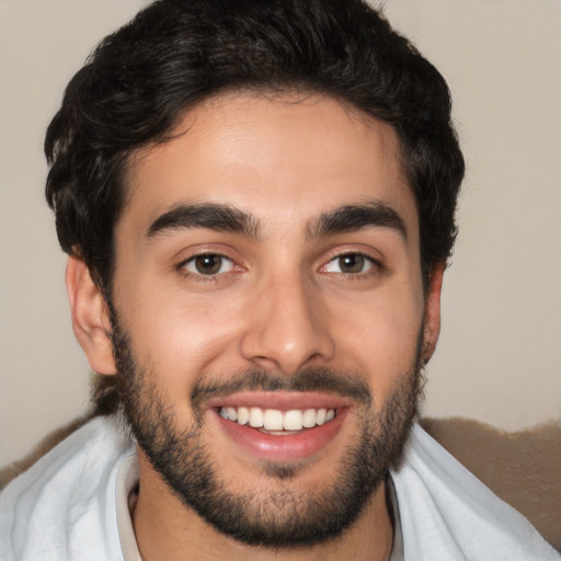 Joyful white young-adult male with short  black hair and brown eyes