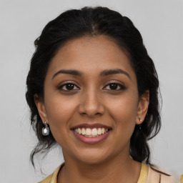 Joyful latino young-adult female with long  brown hair and brown eyes