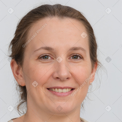 Joyful white adult female with medium  brown hair and grey eyes