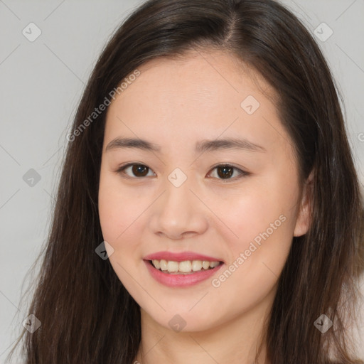 Joyful asian young-adult female with long  brown hair and brown eyes