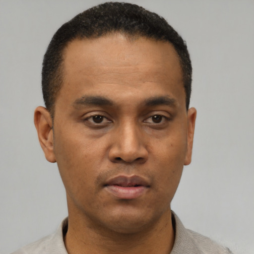 Neutral latino young-adult male with short  black hair and brown eyes