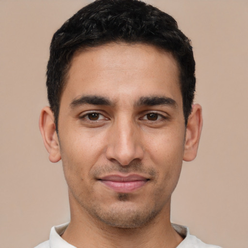 Joyful white young-adult male with short  black hair and brown eyes