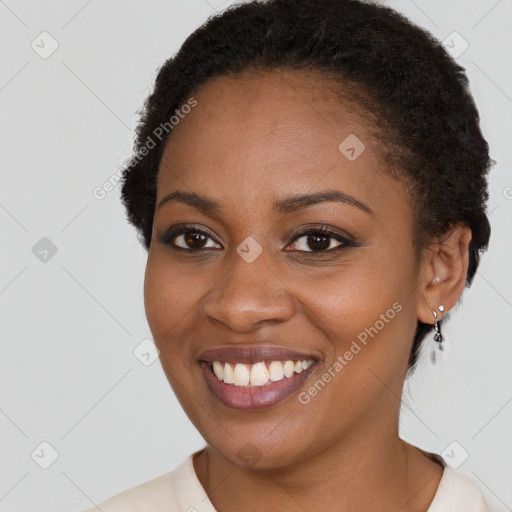 Joyful black young-adult female with short  brown hair and brown eyes