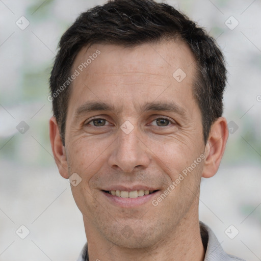 Joyful white adult male with short  brown hair and brown eyes