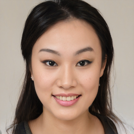 Joyful white young-adult female with medium  black hair and brown eyes