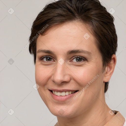 Joyful white young-adult female with short  brown hair and brown eyes