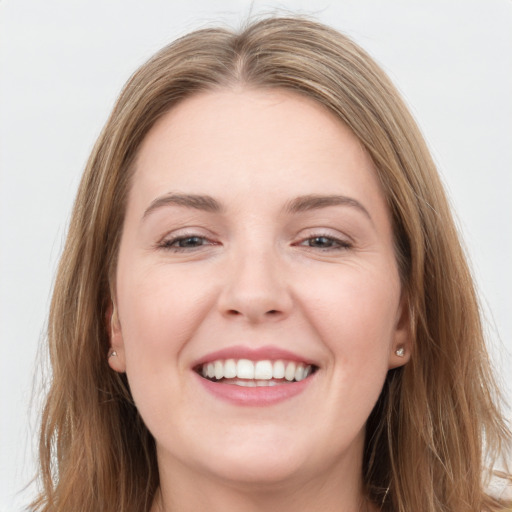 Joyful white young-adult female with long  brown hair and grey eyes