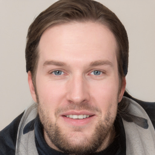 Joyful white young-adult male with short  brown hair and grey eyes