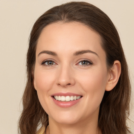 Joyful white young-adult female with long  brown hair and brown eyes