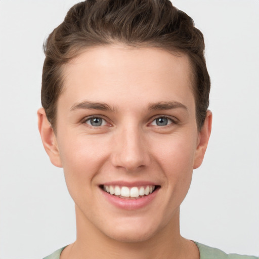 Joyful white young-adult female with short  brown hair and grey eyes