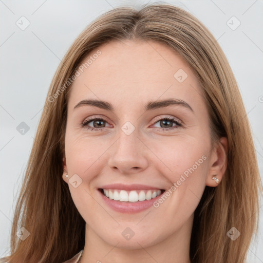 Joyful white young-adult female with long  brown hair and grey eyes