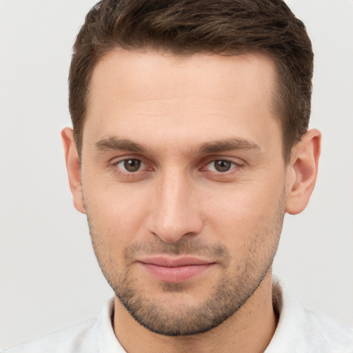 Joyful white young-adult male with short  brown hair and brown eyes