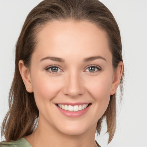 Joyful white young-adult female with long  brown hair and grey eyes