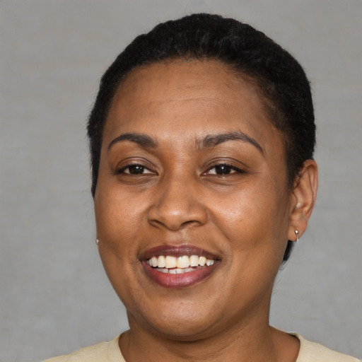 Joyful latino adult female with short  black hair and brown eyes
