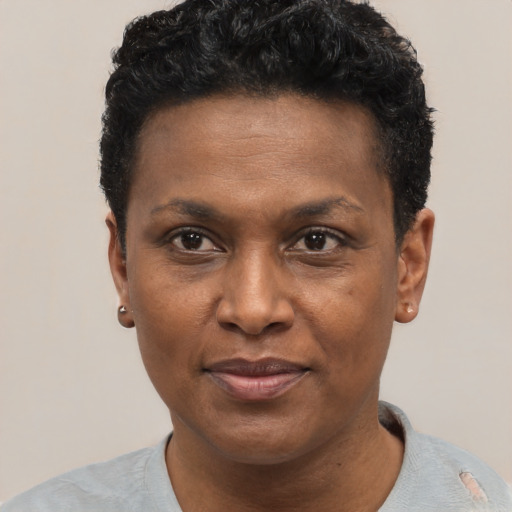 Joyful black adult male with short  black hair and brown eyes