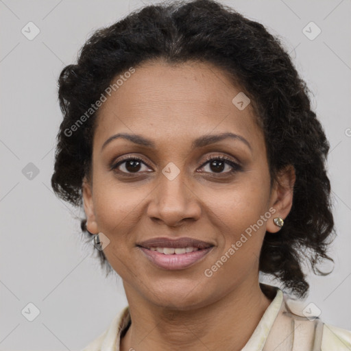 Joyful black young-adult female with long  brown hair and brown eyes