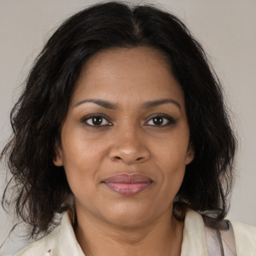 Joyful black young-adult female with medium  brown hair and brown eyes