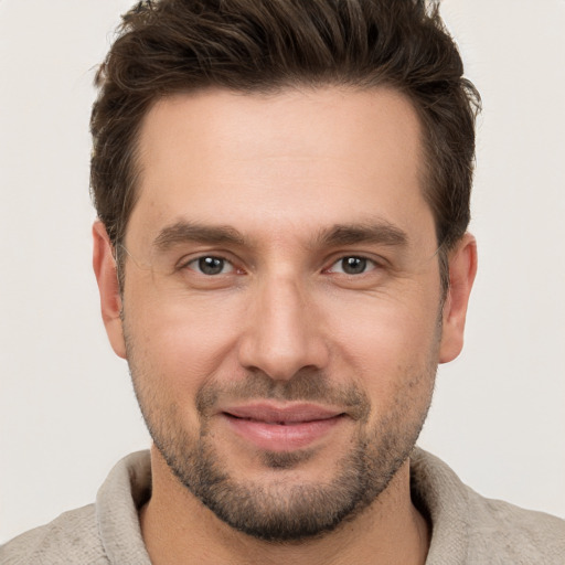 Joyful white young-adult male with short  brown hair and brown eyes