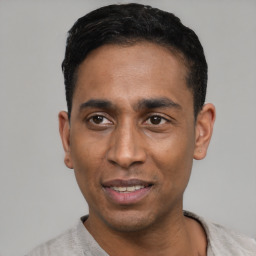 Joyful latino young-adult male with short  black hair and brown eyes