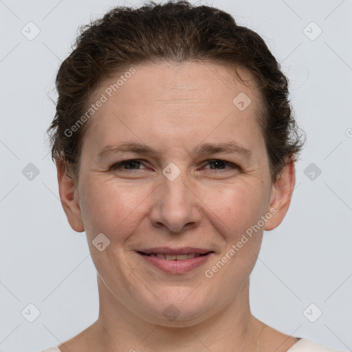 Joyful white adult female with short  brown hair and grey eyes