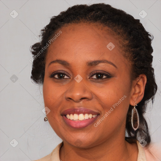 Joyful black young-adult female with long  brown hair and brown eyes