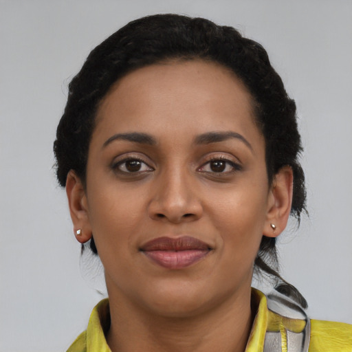 Joyful latino young-adult female with short  black hair and brown eyes