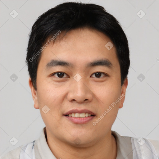 Joyful asian young-adult male with short  black hair and brown eyes