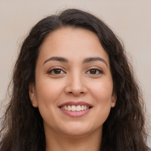 Joyful white young-adult female with long  brown hair and brown eyes