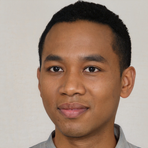 Joyful black young-adult male with short  black hair and brown eyes