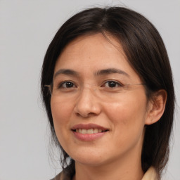 Joyful white adult female with medium  brown hair and brown eyes